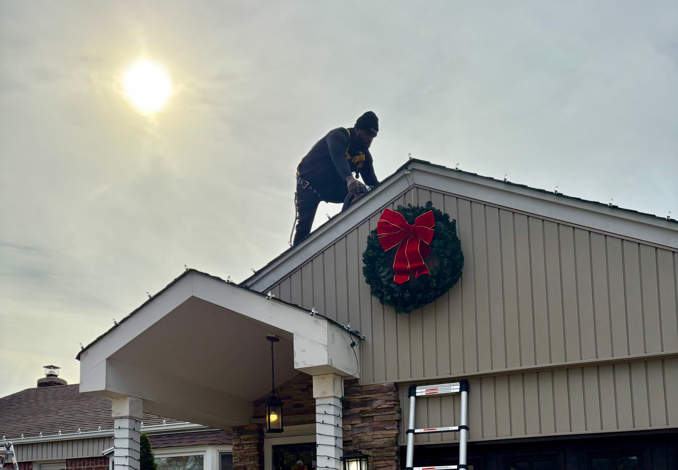 Mosquito Nix Elves installing Christmas lights on Long Island.